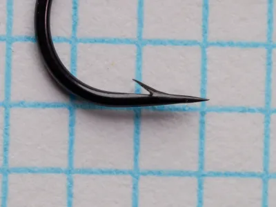 Single Partridge CS7 MW size 10 hook showing sproat bend profile, point detail, and looped up-eye on measurement grid