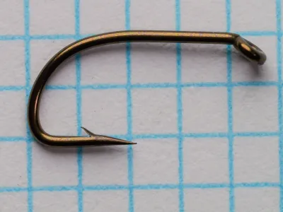 Partridge J1A — hook profile showing tapered eye, Limerick bend, and superior point — size 12 — bronzed finish on measurement grid