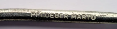 Pflueger Martu Hook — shank stamping showing 'PFLUEGER MARTU' manufacturer mark in relief letters