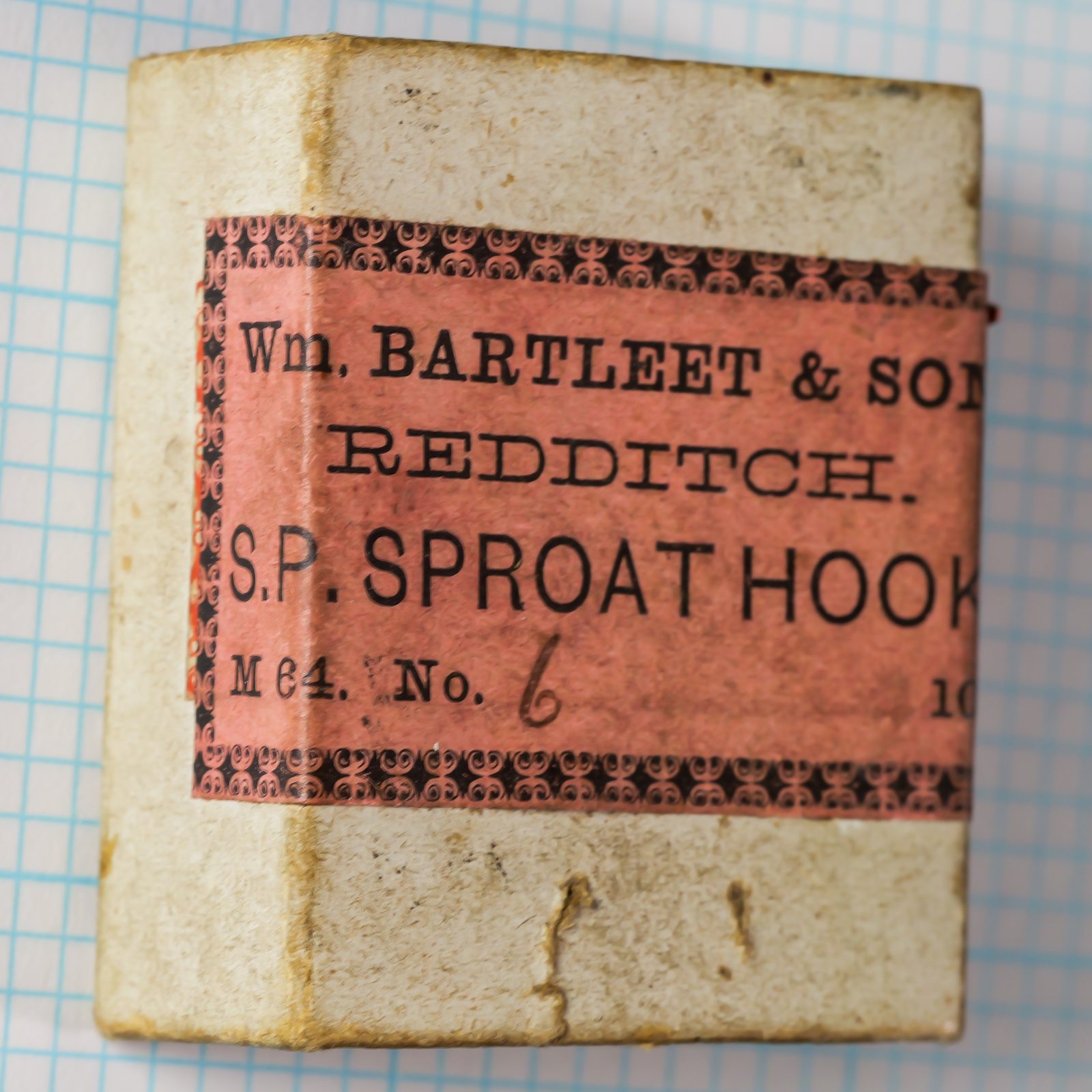 Wm. Bartleet & Sons M64 Sproat Size 6 — original kraft paper box with pink and red printed label showing manufacturer name, model code, and hook designation — Redditch, England