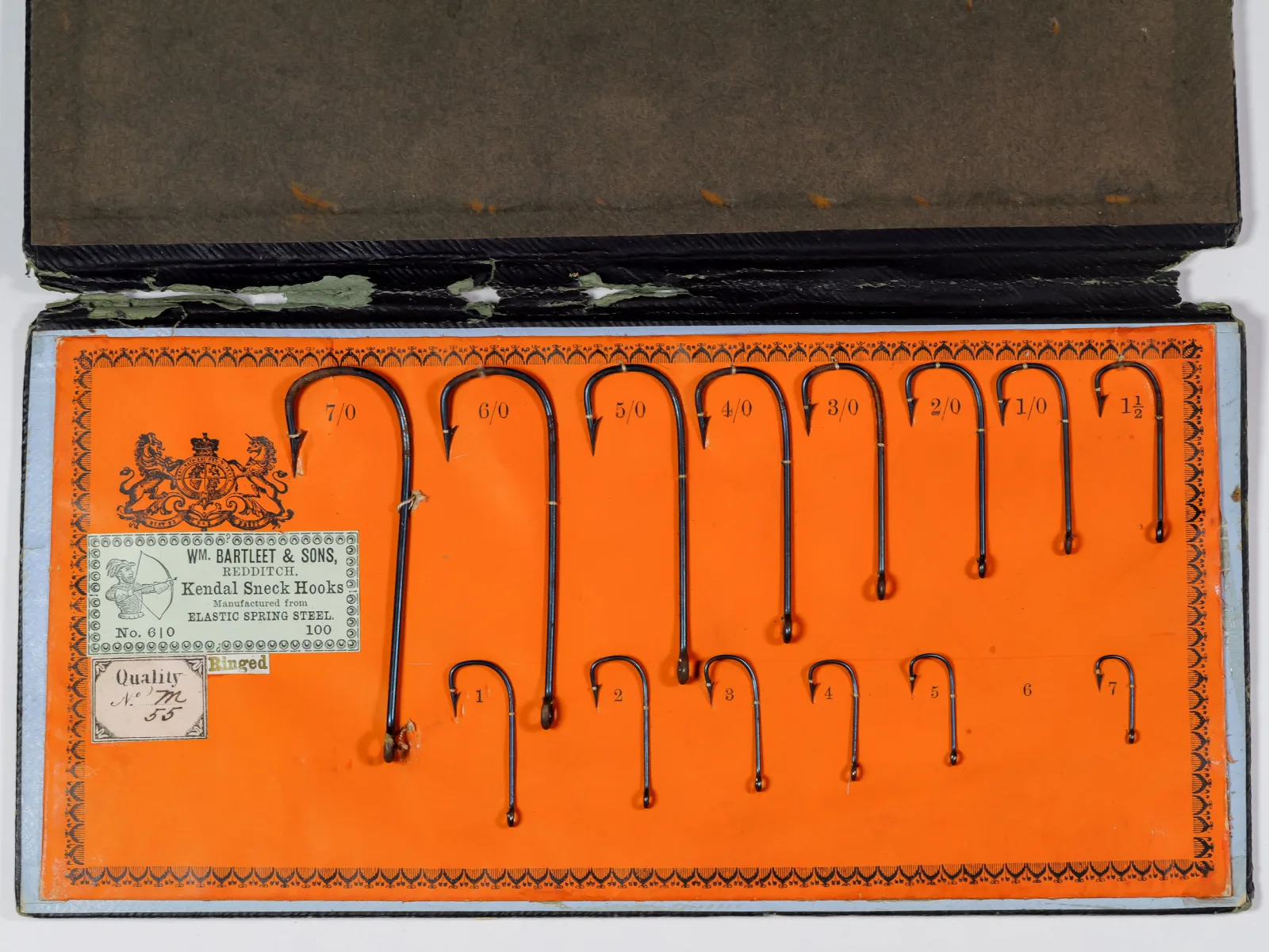 Wm. Bartleet Kendal Sneck Hooks sales card No. 610 — front face showing full card layout with 16 hooks mounted on bright orange card stock, size range 7/0 through 1 and smaller sizes, blued finish visible