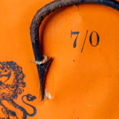 Hook size 7/0 on Bartleet card — detail of point geometry showing blued finish and hollow point profile