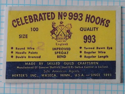 Herter's Celebrated No. 993 No. 12 packaging label — yellow card with burgundy letterpress text, Sheffield steel specification, and shield emblem