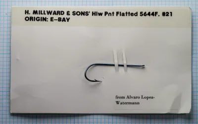 H. Milward & Sons 5644F size 21 hollow point salmon hook mounted on collector documentation card — flatted eye construction and overall proportions visible on measurement grid