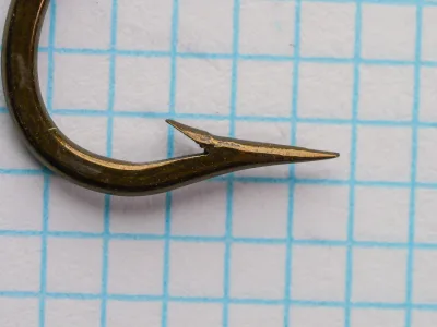 Mustad 3411 — hook point close-up showing geometry and barb — size 3/0 — Superior point with near-straight inner taper