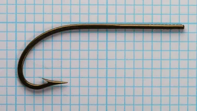 Mustad 3411 — side profile on measurement grid — size 3/0 — showing O'Shaughnessy bend, blind eye taper, marked shank, and overall proportions