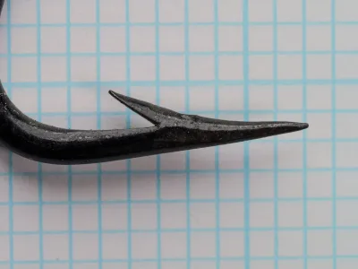 Mustad 4513 Limerick hook, side profile view showing bent shank and point.