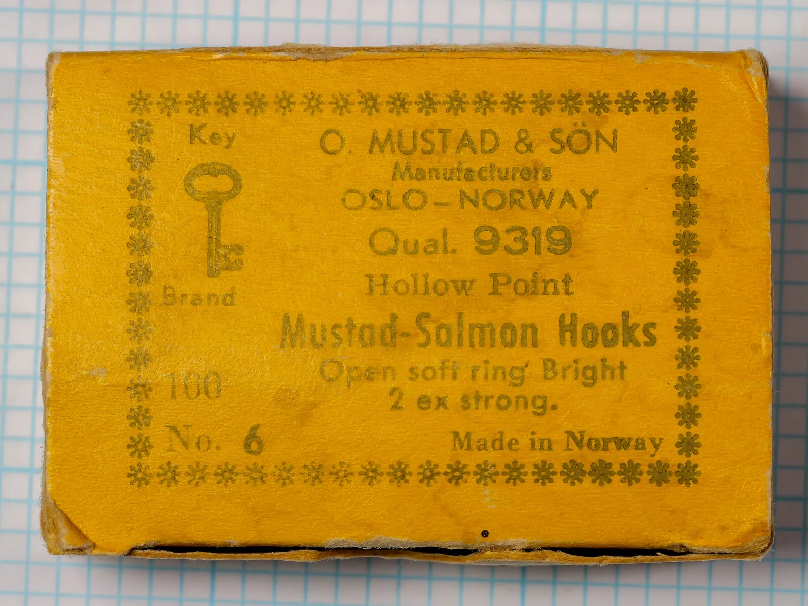 Mustad 9319 salmon hook — yellow paper manufacturer box with Key Brand logo and star border — size 6 — showing printed specifications and packaging condition