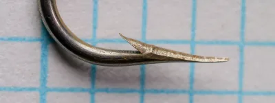 Mustad 9319 hook point — profile view showing concave inner face geometry — size 6 — Hollow Point specification