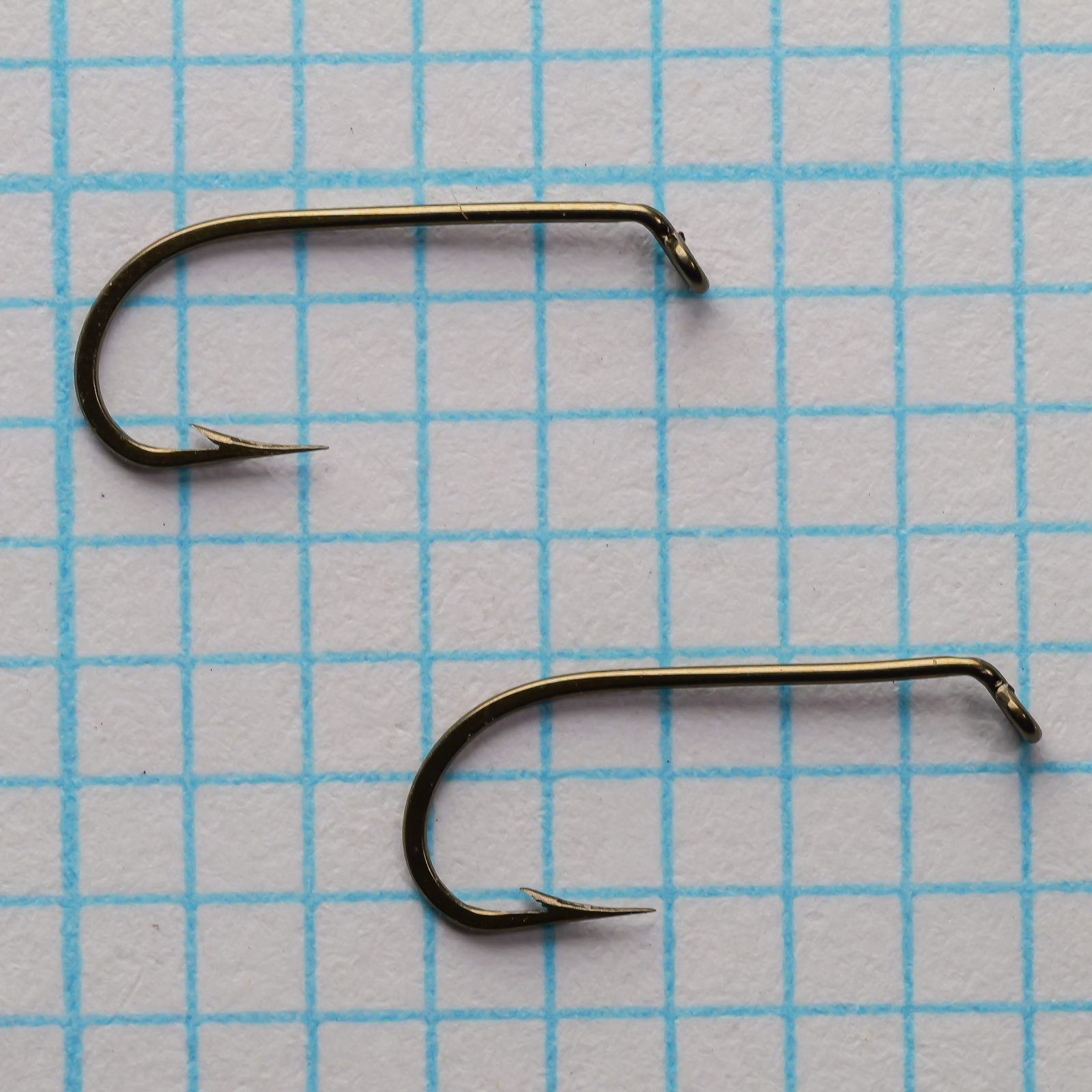 Mustad 94833 hooks — overhead view comparing two specimens — size 12 — bronzed finish showing bend geometry