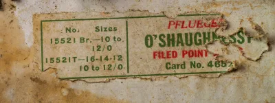 Pflueger O'Shaughnessy Card No. 4652 — sales card label detail showing model number 15521 Br., size range 10 to 12/0, and 'Filed Point' designation in green and red letterpress printing