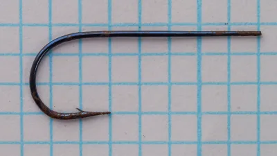 Partridge Round-Bend Extra-Fine Wire — overhead view of hook showing bend profile and tapered blind eye — size 6 — blued finish