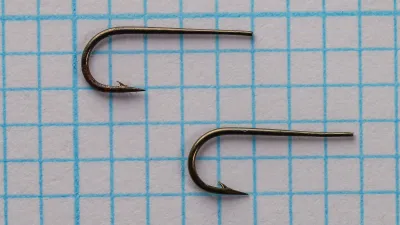 Partridge Round Taper Size 11 — two hooks angled view showing gap width and bend depth — bronzed finish