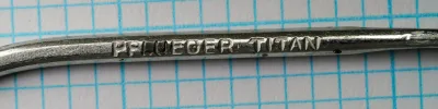 Pflueger Titan 10015T — shank detail showing stamped 'PFLUEGER TITAN' marking and hammer marks — size 8/0 — hand-forged construction evidence