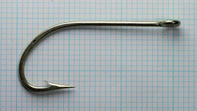 Pflueger O'Shaughnessy 15521-T — full hook profile showing straight-ring eye, shank, and O'Shaughnessy bend — size 9/0 — tinned finish
