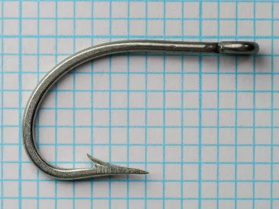 Pflueger 25521-T O'Shaughnessy Hook — side profile showing bend and ring eye — size 4/0 — tinned finish on measurement grid