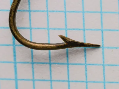 Pflueger Carlisle 3321-Br hook — side profile showing point geometry, ringed eye, and sproat bend curvature — on 1/10-inch measurement grid — size 1/0