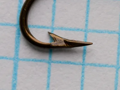 Pflueger Sproat 3521-Br No. 10 — close-up of hook point and barb showing mechanically filed superior point geometry and bronzed finish color