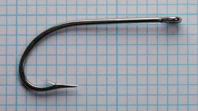 Mustad 34007 Size 3/0 — large hook in profile showing oversized O'Shaughnessy bend and forged shank characteristics