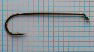 Mustad 9672 Size 2 — full hook profile — top-down view — showing characteristic shank length and sproat bend on measurement grid