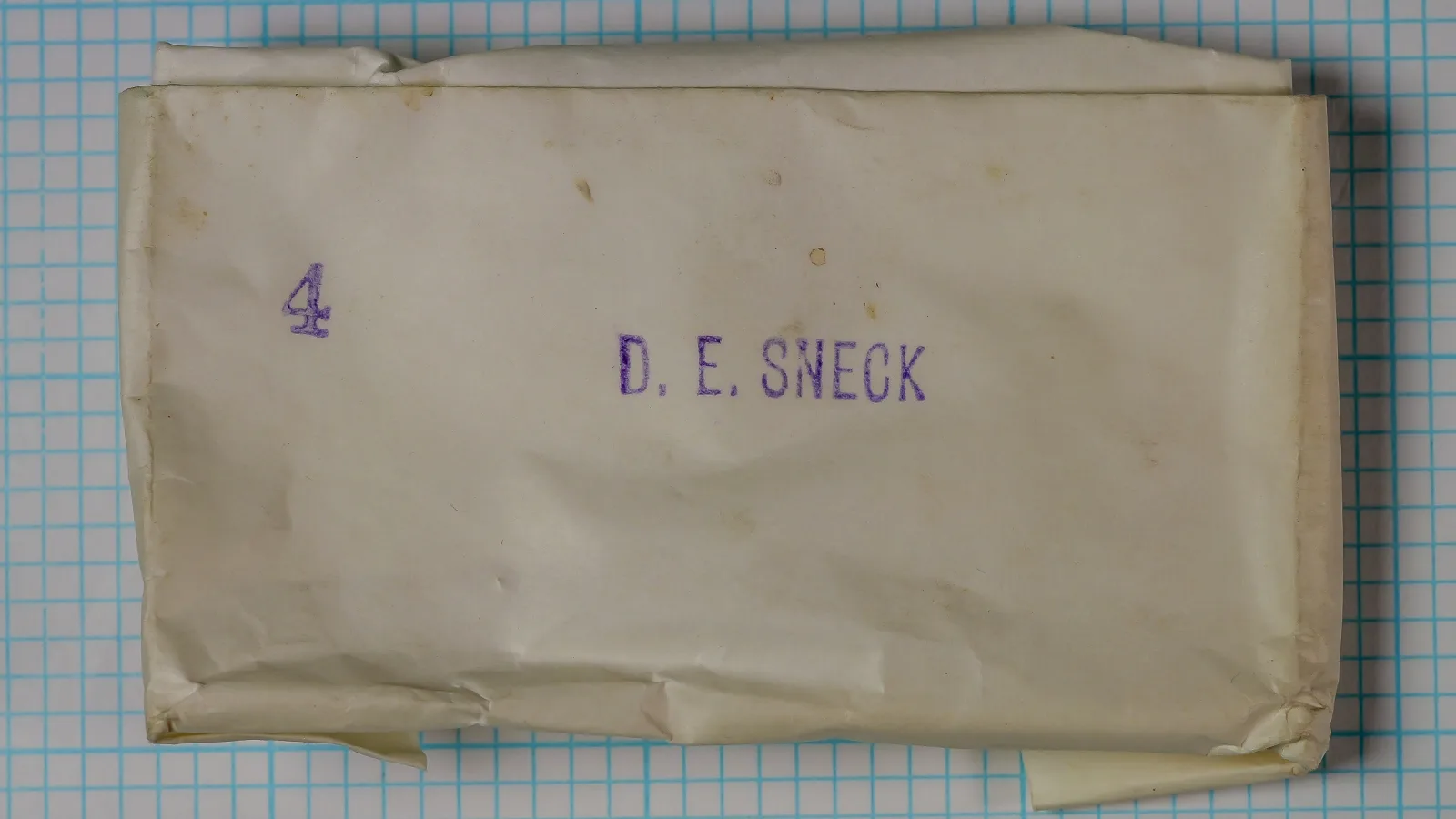 Partridge D.E. Sneck hook packaging — kraft paper envelope with hand-stamped size marking — size 4 — showing vintage Redditch manufacturing envelope