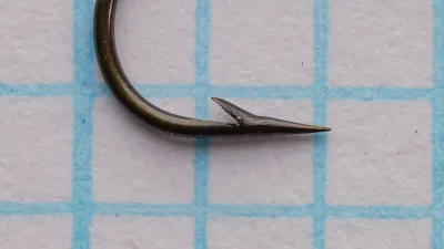 Partridge F.W. Round Taper — point and barb detail — size No. 9 — tapered blind eye visible from front face with bronze finish