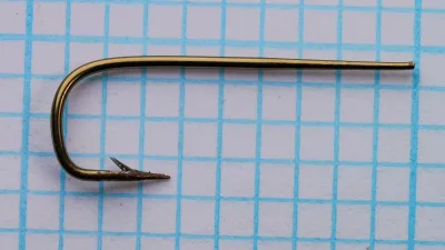 Partridge Sneck Taper — overall profile view showing tapered blind eye and sneck bend — size 4 — bronzed finish on measurement grid