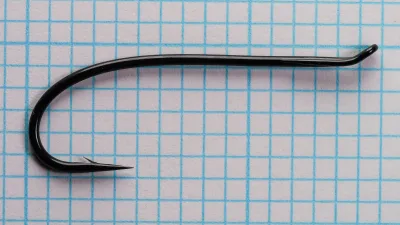 Tiemco TMC 7999 Hook Full Profile — size 1/0 — showing loop eye, shank, and bend geometry on measurement grid