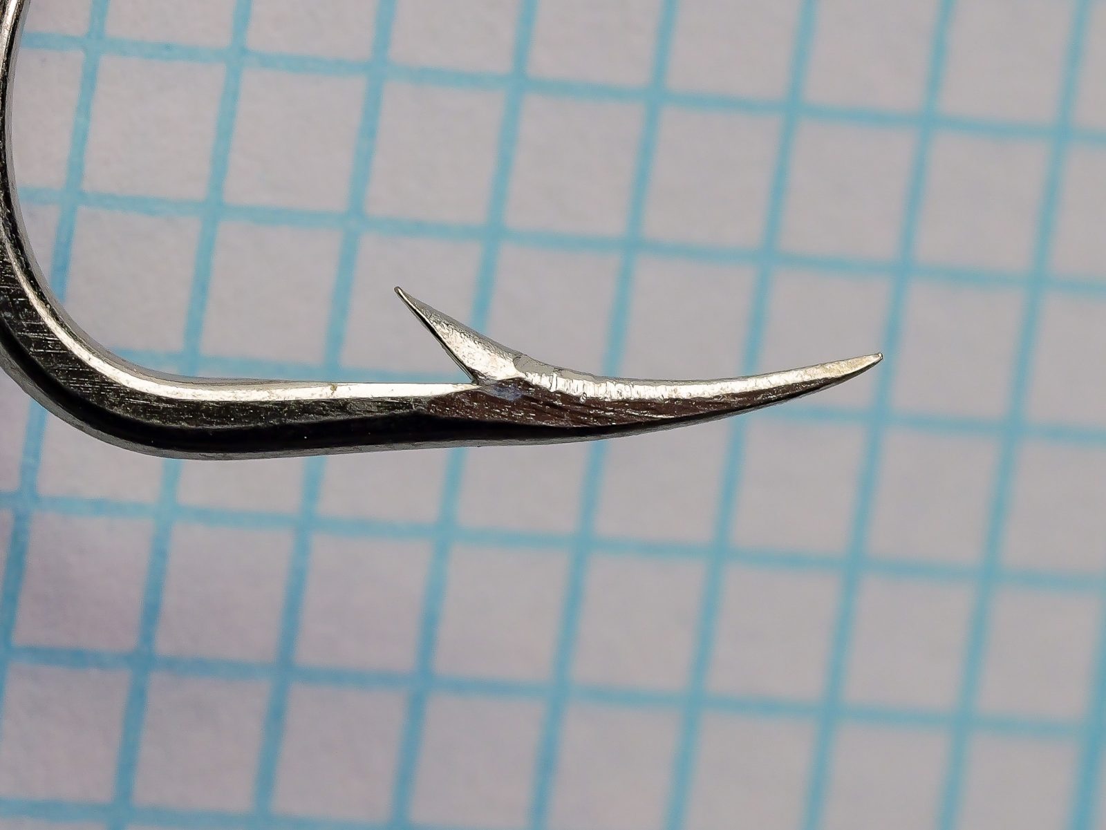 Mustad 92615 Beak Hook — macro close-up of point and bend — size 2/0 — hollow point concave inner surface detail