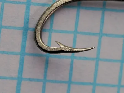 Mustad 92620 Beak Hook — close-up of point — size 10 — reversed inward-curving beak geometry with barb