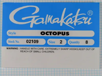 Gamakatsu Octopus packaging — blue card with white label bands showing Style OCTOPUS, Stock 02109, Size 2, Quantity 8, and safety warning
