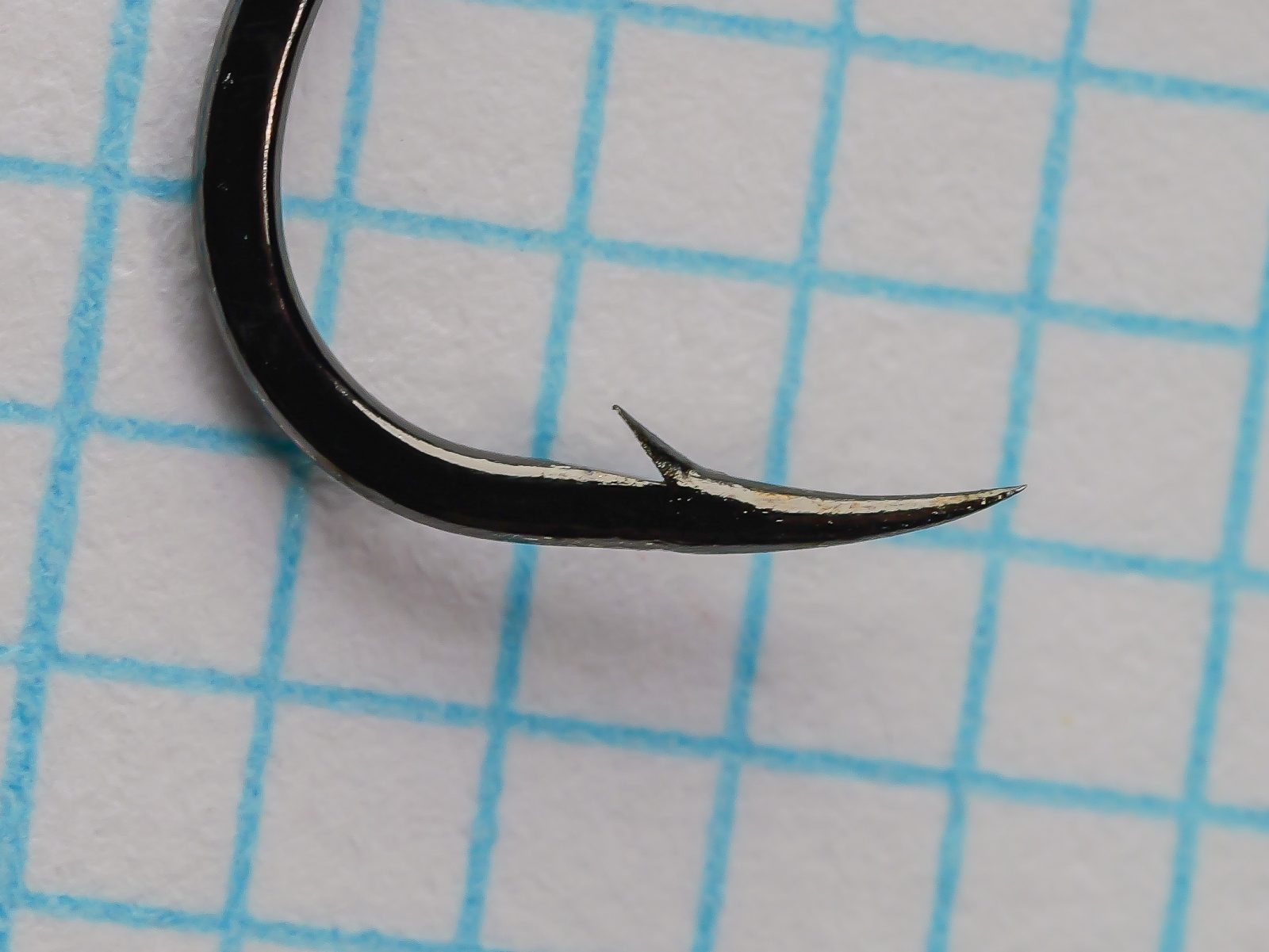 Gamakatsu 02408 Octopus Hook Size 4 — close-up of point and barb — nickelled finish — showing concave hollow point geometry and near-straight barb