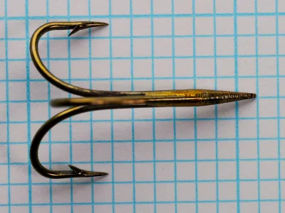 Mustad 3601 Treble Hooks — top-down view showing three barbs, hollow-point geometry, and tapered eye junction — size No. 2 — bronzed