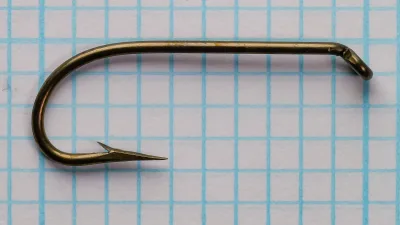 Eagle Claw 1197N Size 4 hook — close-up front face on measurement grid — bronzed finish showing Sproat bend and turned-down ball eye