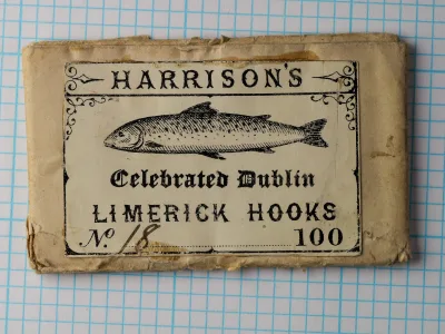 Two Harrison Celebrated Dublin Limerick size 18 hooks next to US dime for scale, japanned finish, straight eye