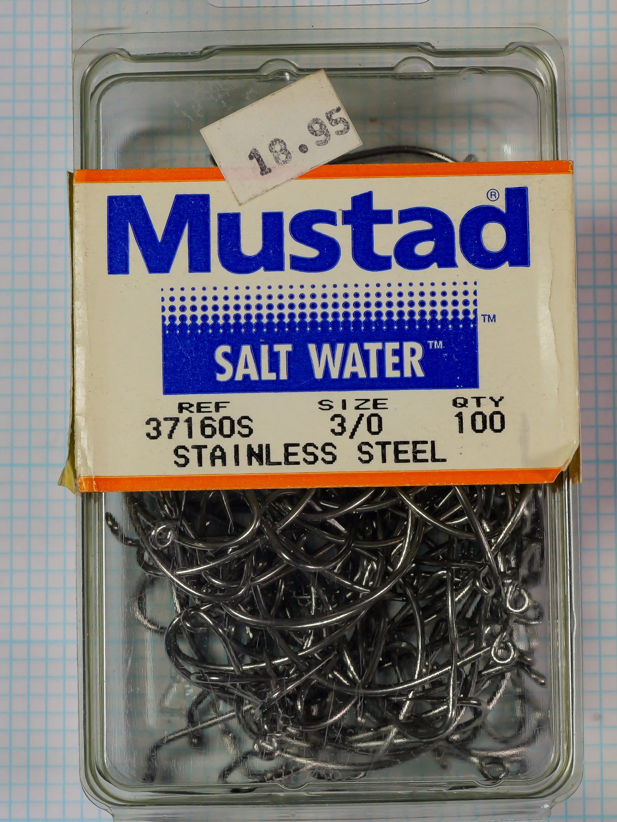 Mustad 37160S package — full clamshell view showing plastic container with adhered label and visible hooks inside