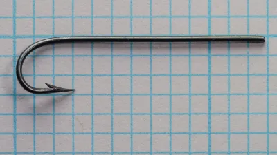 Mustad 3719 — complete hook profile showing tapered blind eye, Sproat bend, and overall proportions — size 7 — blued finish