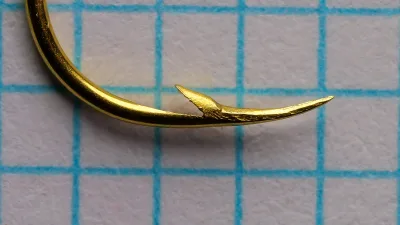 Mustad 37363 Aberdeen — close-up of hook point showing barb position and superior point geometry — size 3 — gold-plated