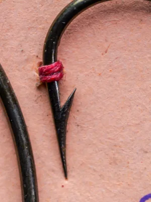 Mustad 3840 Centripetal Hook — closeup of tapered blind eye and hollow point geometry — size 1/0 — bronzed finish specimen with red silk thread tie