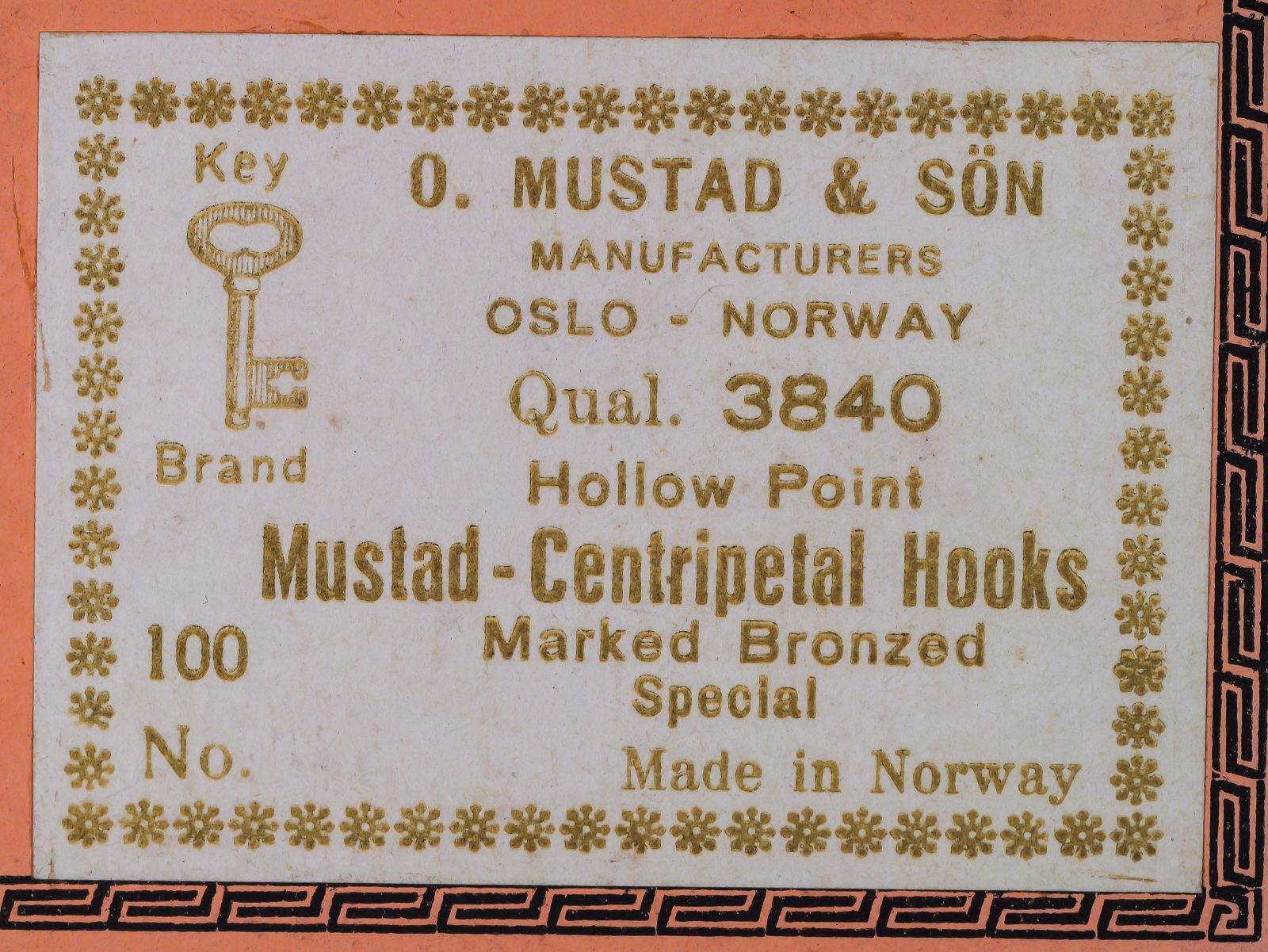 Mustad 3840 label — text detail reading 'O. MUSTAD & SON MANUFACTURERS OSLO - NORWAY Qual. 3840 Hollow Point Mustad-Centripetal Hooks Marked Bronzed Special Made in Norway' — gold letterpress on cream background