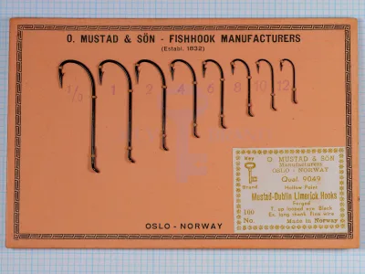 Mustad 9049 product label close-up with gold text on white background, specifications and manufacturing details