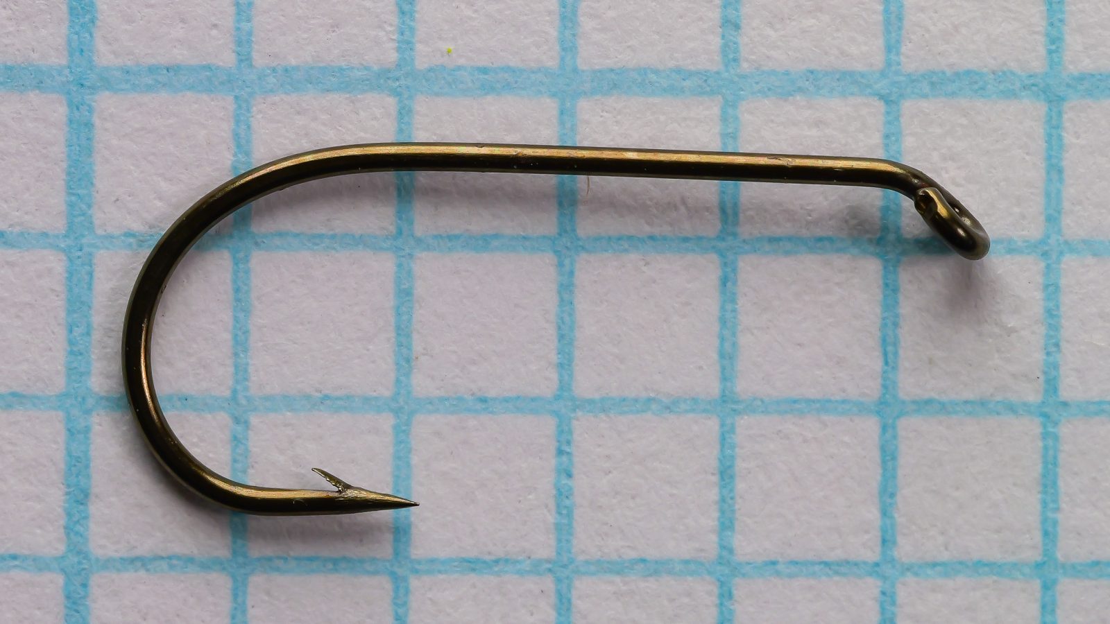 Partridge L4A Captain Hamilton Featherweight Size 14 — side view of single hook showing bend profile and tapered down eye — on 1/10-inch measurement grid