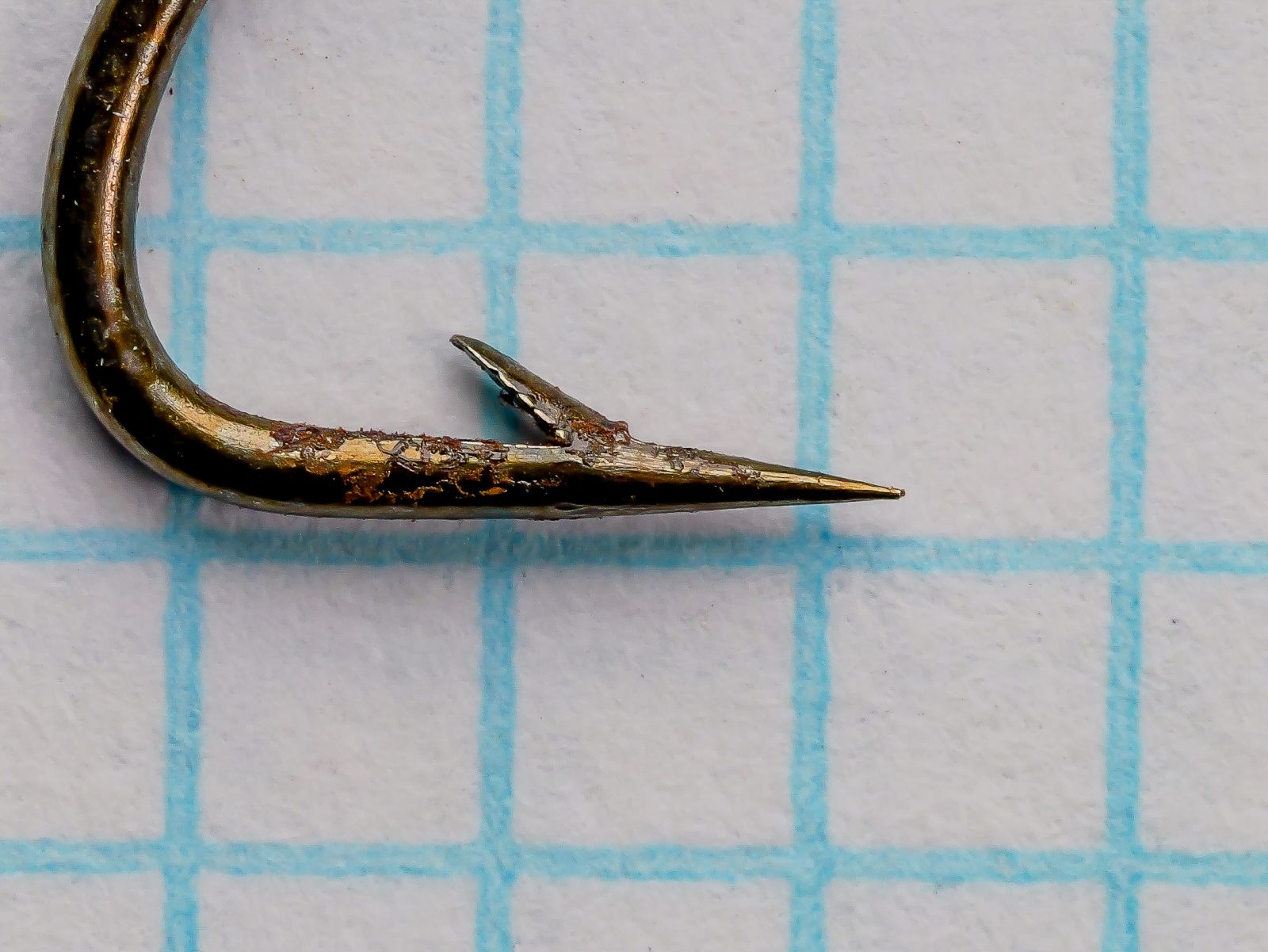 Partridge Limerick Minnow Turned Ends — profile view showing tapered shank, angular Limerick bend, and bronzed finish — size 5 — photographed on 1/10-inch measurement grid
