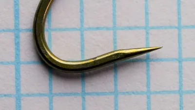 Tiemco TMC 200R/BL size 4 — lateral side profile of hook showing bend geometry and semi-dropped point — bronzed finish with measurement grid