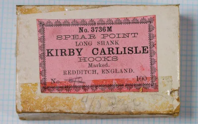 Allcock No. 3736M packaging — pink sales card with decorative border, printed text, scale ruler — indicating 100-hook quantity, Redditch manufacturer