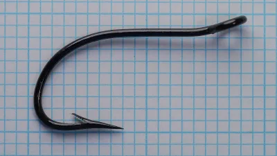 Full hook profile of japanned sproat bend fishing hook against metric grid.