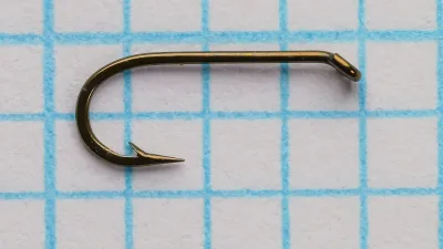 Nyack TDE hook size 18 — profile showing tapered eye turned down and bend shape — bronzed finish — on measurement grid