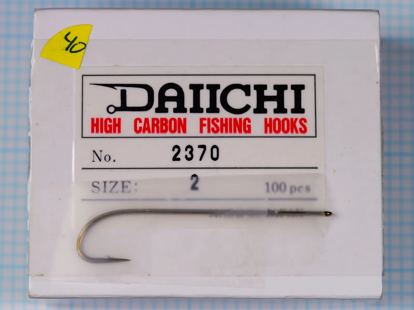 Daiichi 2370 — Original packaging front with hook specimen mounted on graph paper grid — Size 2 — Bronzed finish