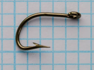 Mustad 199 B reversed beak hook — top-down view showing reversed point offset and beak bend depth — size 6 (No. 6) — bronzed finish — on measurement grid