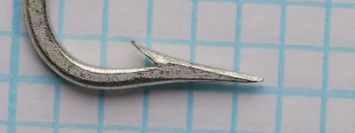 Mustad O'Shaughnessy size 2/0 hook — bend profile and point detail showing Superior point geometry and barb placement — side view